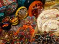Kolorowe pamiątki z Cypru: ceramiczne miseczki, talerzyki z motywami kwiatowymi i morskim, bransoletki z "oka proroka".
