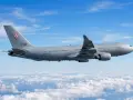Szary samolot Airbus A330-300 z numerem 3301 i polską szachownicą na ogonie leci nad chmurami.