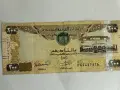 Banknot 200 dirhamów Zjednoczonych Emiratów Arabskich. AED jaka to waluta, widzimy orła i budynek.