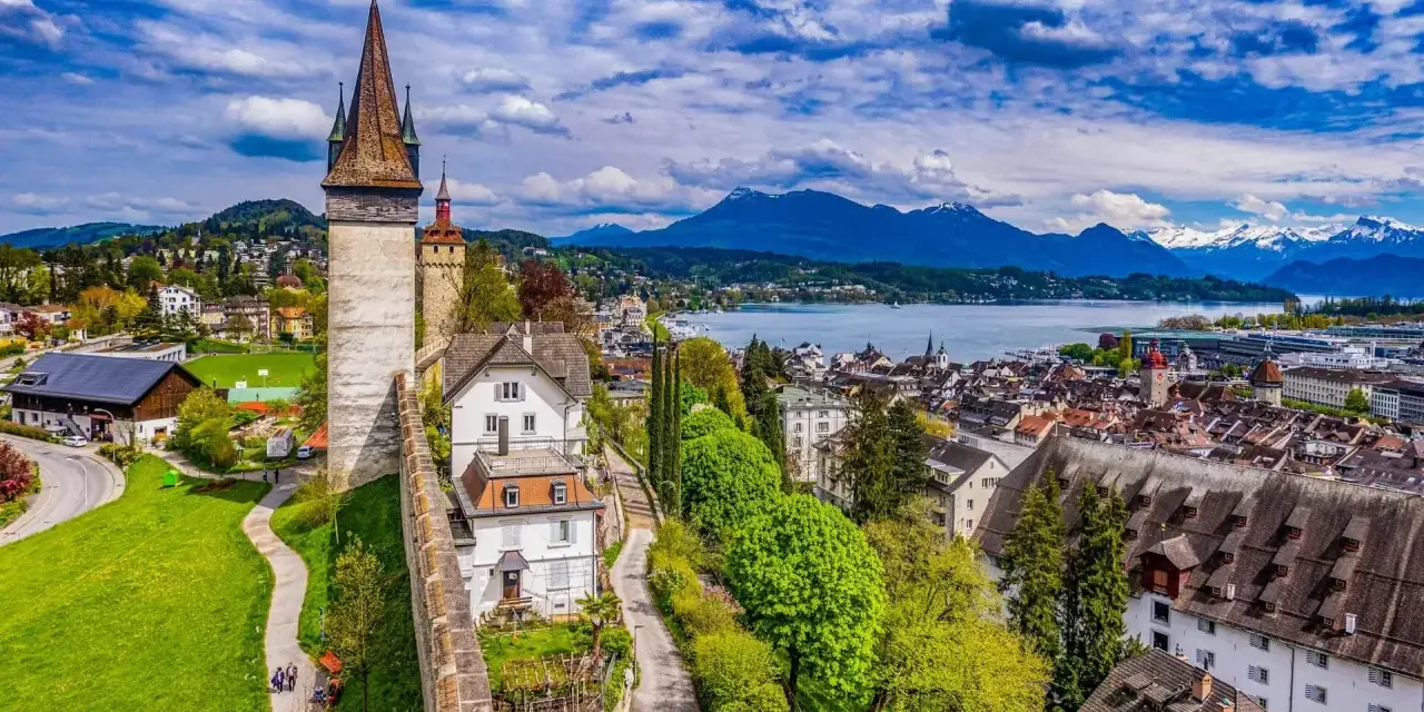 Widok na malownicze miasto Lucerna w Szwajcarii, z górami w tle i jeziorem.